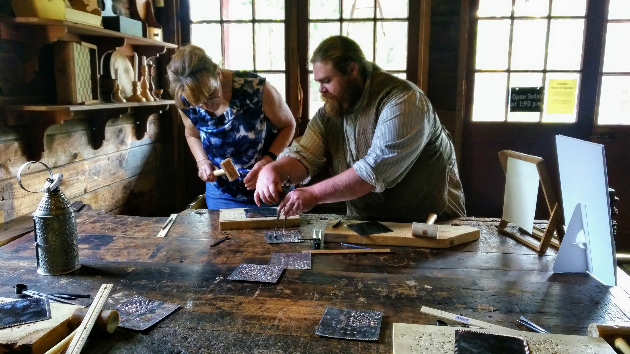 Black Creek visitor works as apprentice with village tinsmith