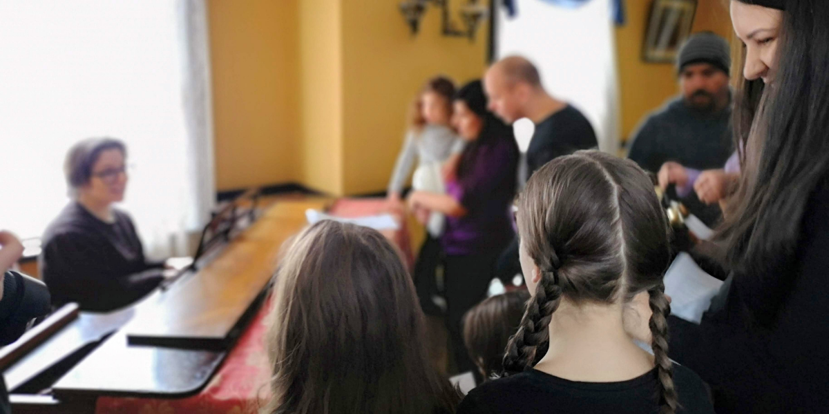 People watching a person play the piano