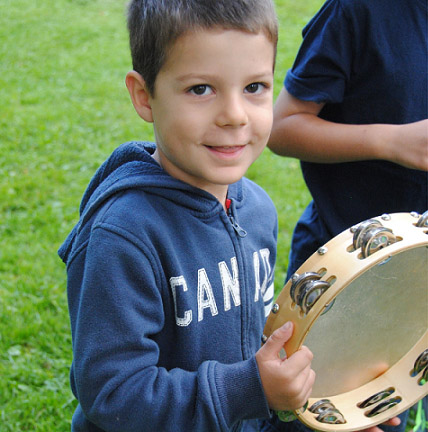 boy holding tambourine