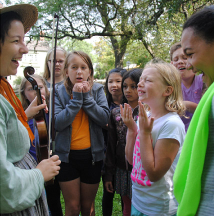 fiddler demonstrates instrument for children