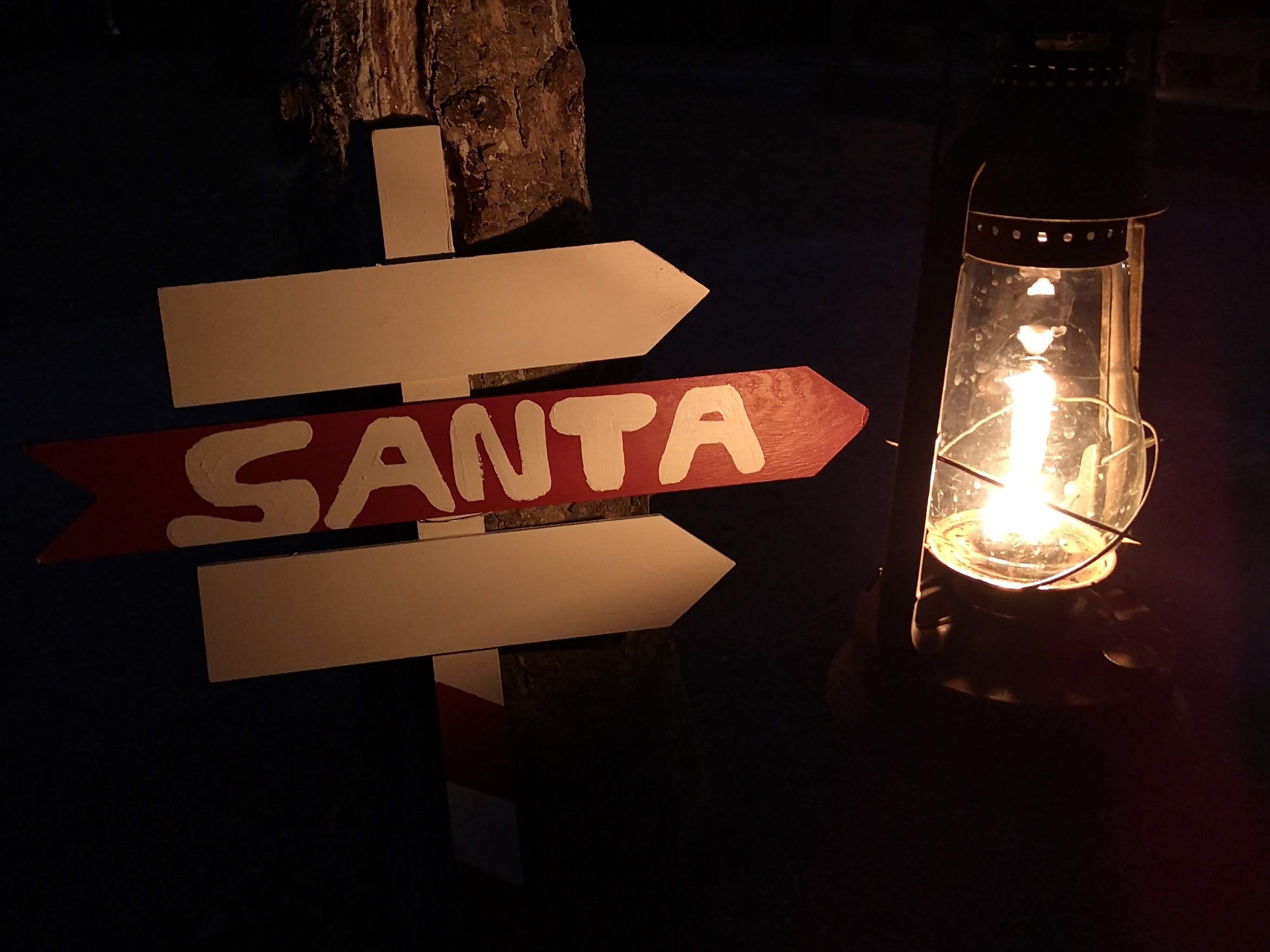 A sign pointing to the direction of Santa Clause
