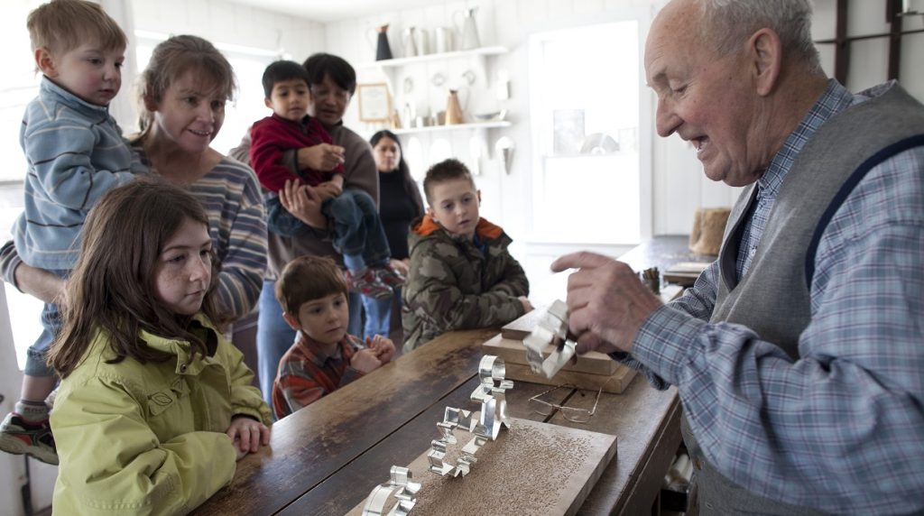 families visit tinsmith shop during Black Creek Village home school day workshop