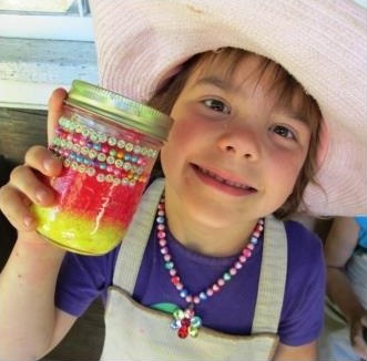 young girl makes crafts at Black Creek Village summer day camp