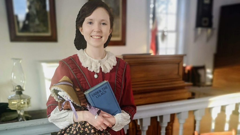A pioneer woman holding a book