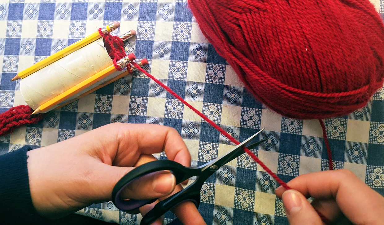 crafter cuts yarn