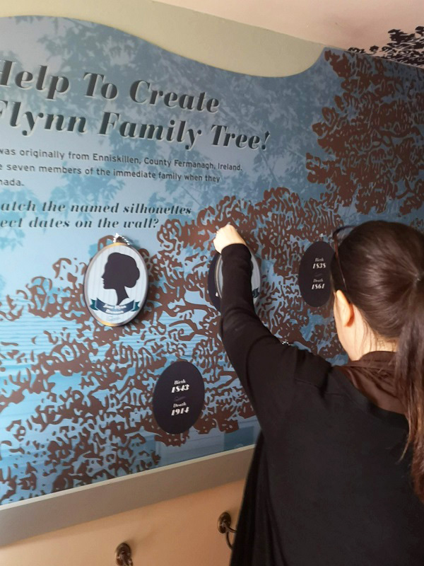 visitor to Flynn House exhibit at The Village at Black Creek examines the family tree