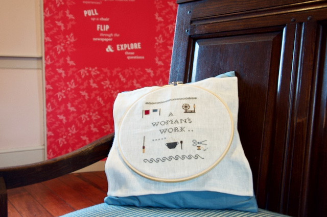 An embroidered pillow in the Girls Bedroom portion of the Flynn House exhibit tells part of the story of women in the 19th century