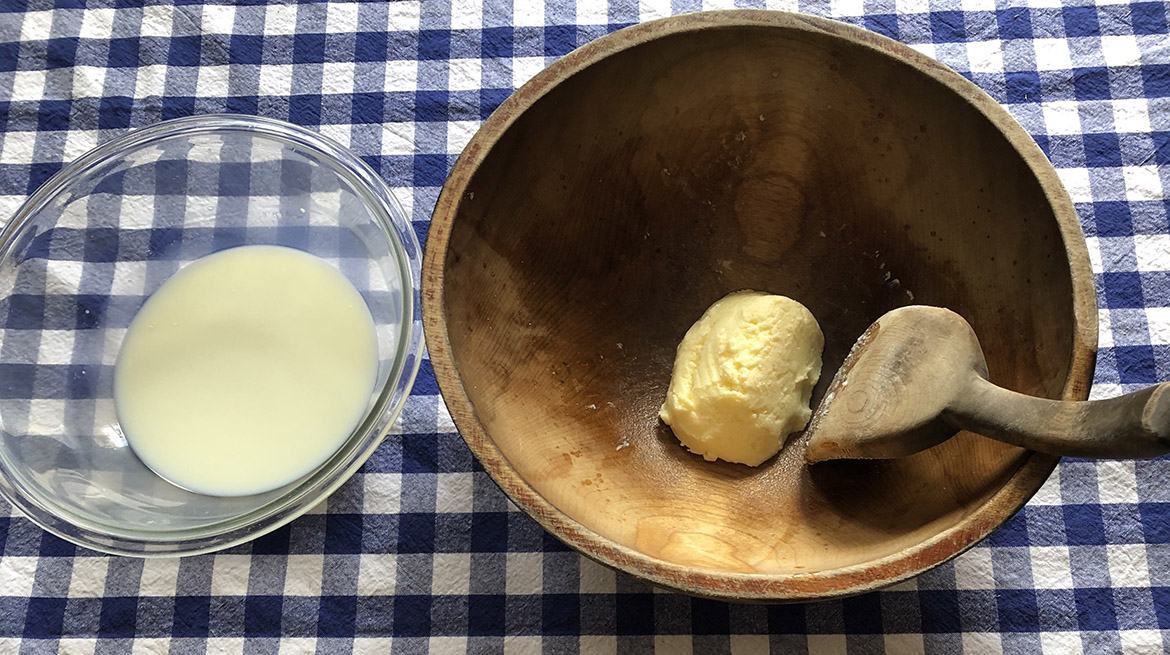 bowl of butter with buttermilk in separate bowl