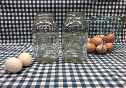 eggs sit next to jars filled with cold water