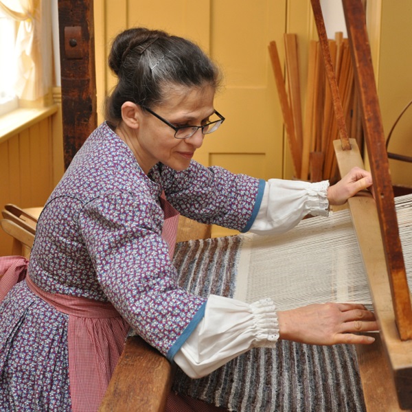 a weaver works on a loom