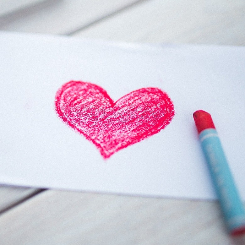 heart drawn on sheet of paper with red crayon