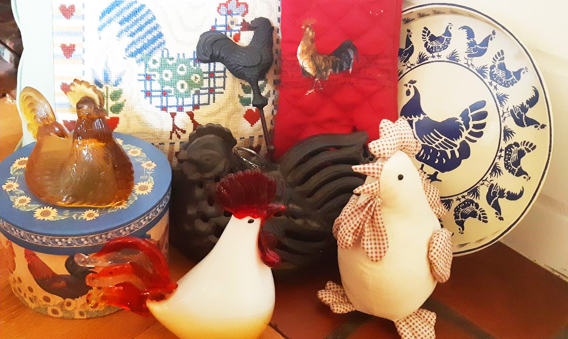 collection of chicken figurines and other chicken related items