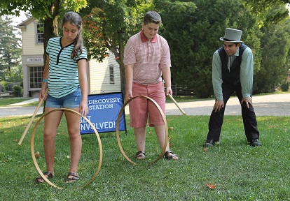 students learn to play traditional Victorian stick and hoop game