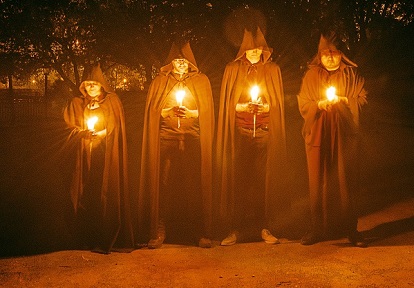 hooded figures with candles stalk the streets of the Village as part of the Where Dark Things Dwell escape game experience at Black Creek
