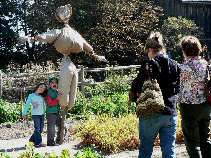 a young family tours Black Creek Village in the fall