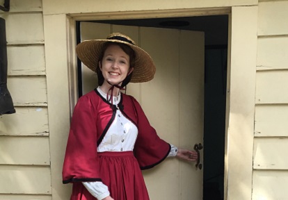 Costumed educator leads a guided weekday tour of Black Creek Village