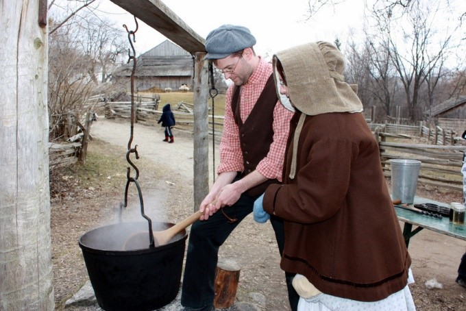 costumed educators at Black Creek Village concoct a witches brew