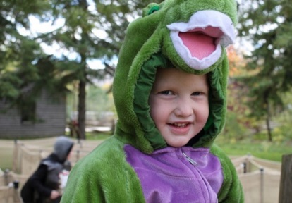 child in costume enjoys Halloween at the Village
