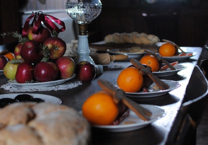wooden table spread with traditional Victorian Christmas delicacies