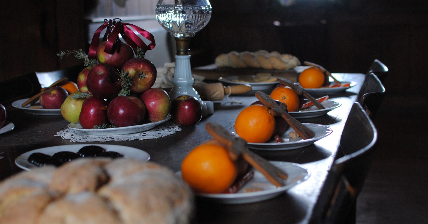wooden table spread with traditional Victorian Christmas delicacies