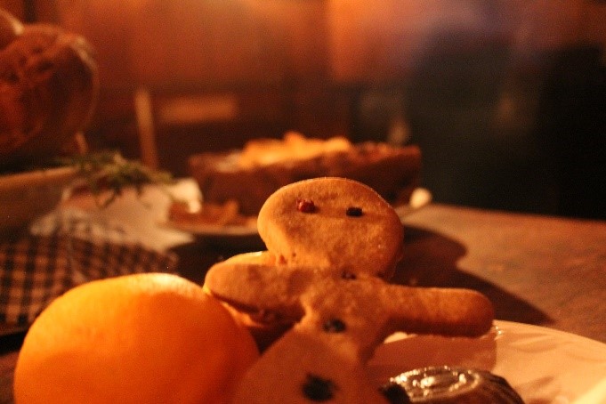 visitors enjoy a freshly baked gingerbread man during Christmas at the Village event