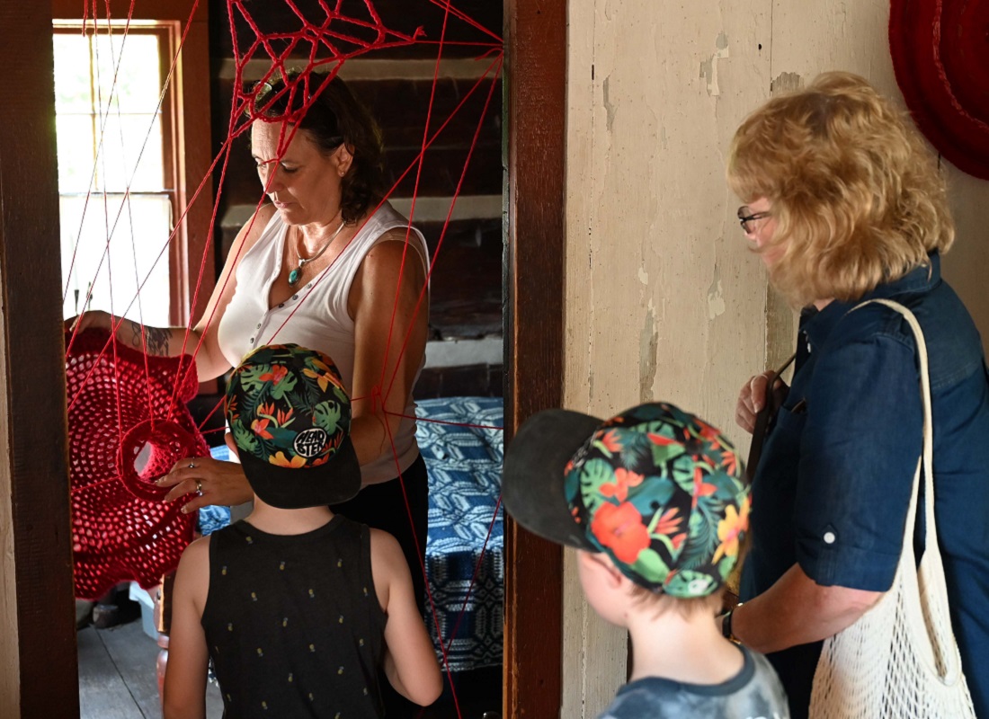 artist Tracey-Mae Chambers greets visitors to her Hope and Healing installation at The Village at Black Creek