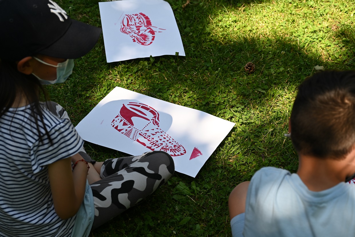 students create moccasin stencils as part of the Walking Together education workshop at The Village