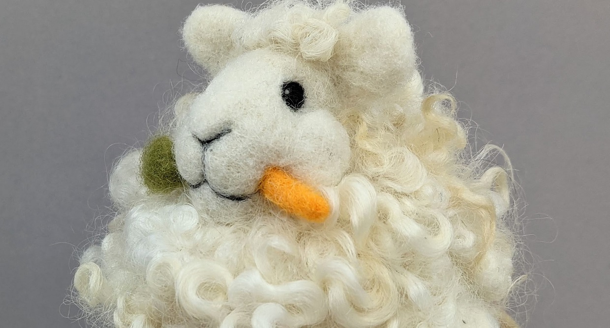 needle felted sheep figure with carrot