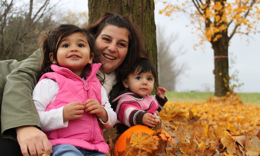 mother and young daughters enjoy autumn festivities during Thanksgiving Fun event at Black Creek Pioneer Village
