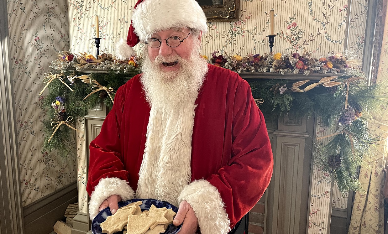 Santa Claus greets holiday visitors to Black Creek Pioneer Village with a plate of old fashioned sugar cookies