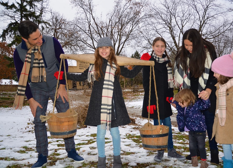 a young family explores Black Creek Pioneer Village on a winter day