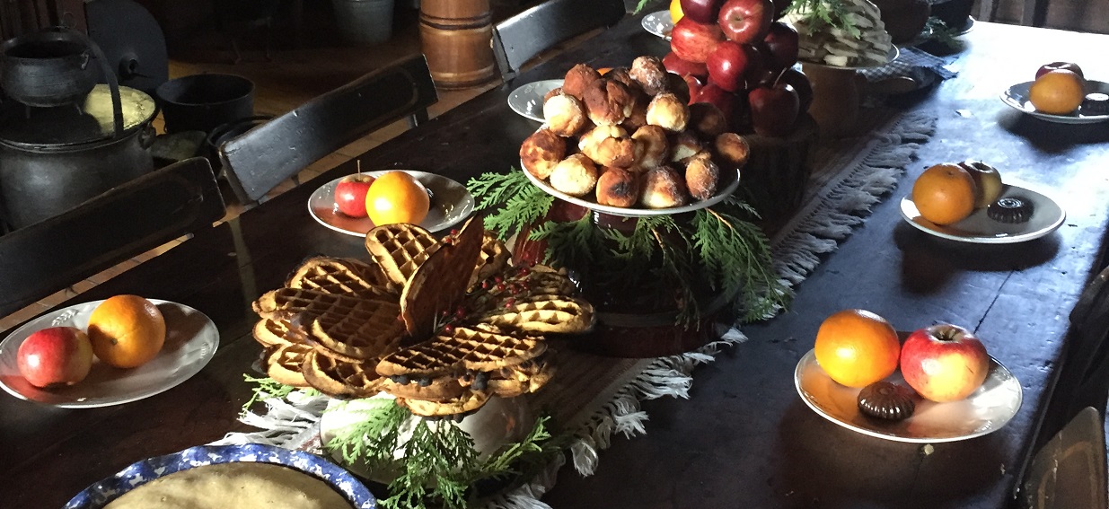 a wooden dining table at Black Creek Pioneer Village is laden with traditional Victorian Christmas treats