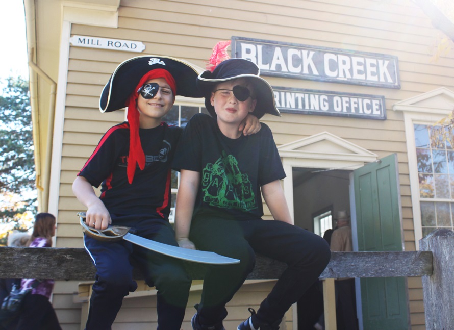 youngsters in pirate costumes enjoy Halloween activities on a sunny October afternoon at the Village at Black Creek