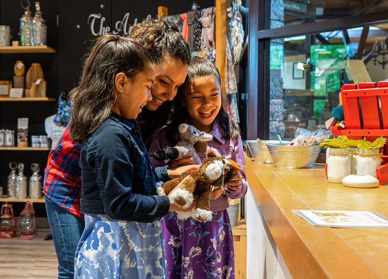 mother and daughters explore the gift shop at the Village at Black Creek