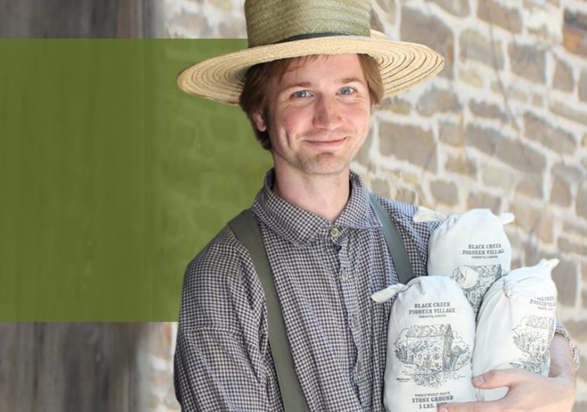 a costumed educator at The Village at Black Creek