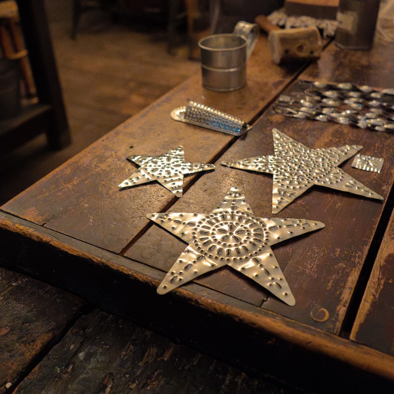 handmade tin holiday decorations on display at The Village at Black Creek