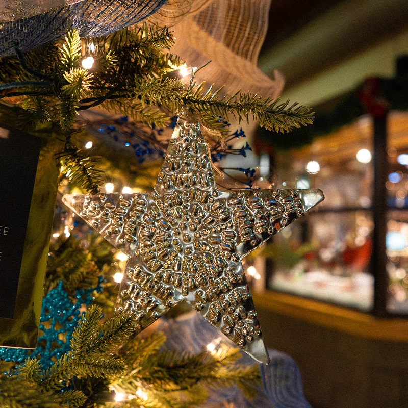 a handmade holiday decoration adorns a Christmas tree at The Village at Black Creek