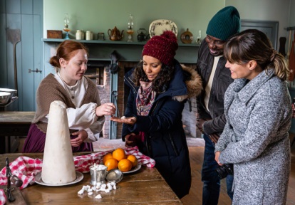 visitors learn about 19th century holiday traditions from a costumed educator during a weekday tour of The Village at Black Creek