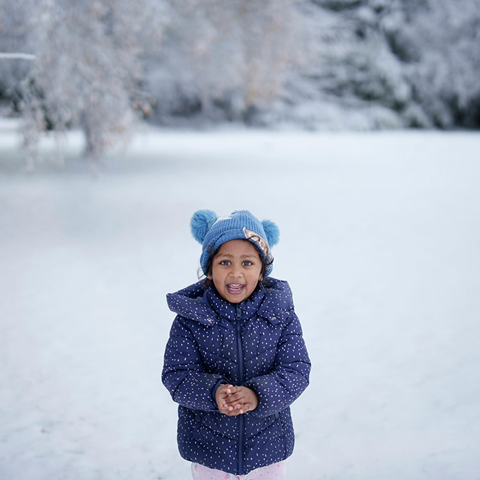 A kid on a snowy day at the Village at Black Creek