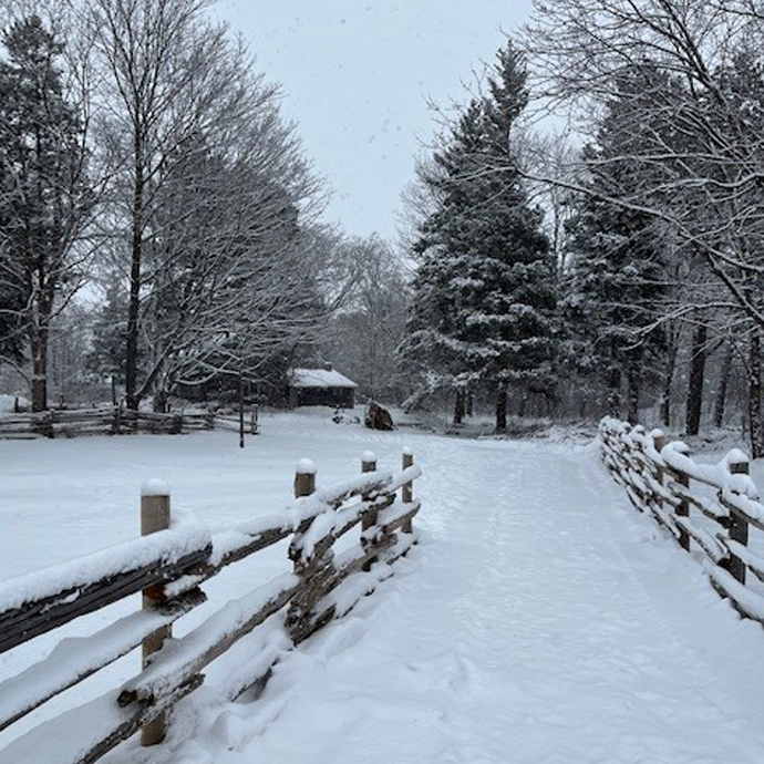 view of snow-covered streets at the Village at Black Creek on a winter day