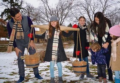 a young family explores The Village at Black Creek during the March Break maple days event