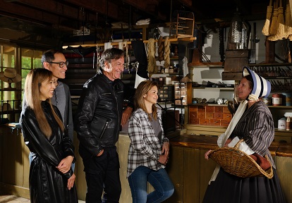 corporate group members join a costumed educator to explore The Village at Black Creek