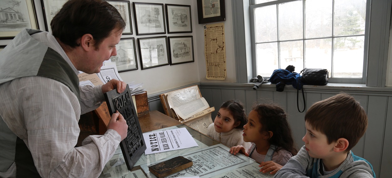 summer campers visit the Printing Office at The Village at Black Creek
