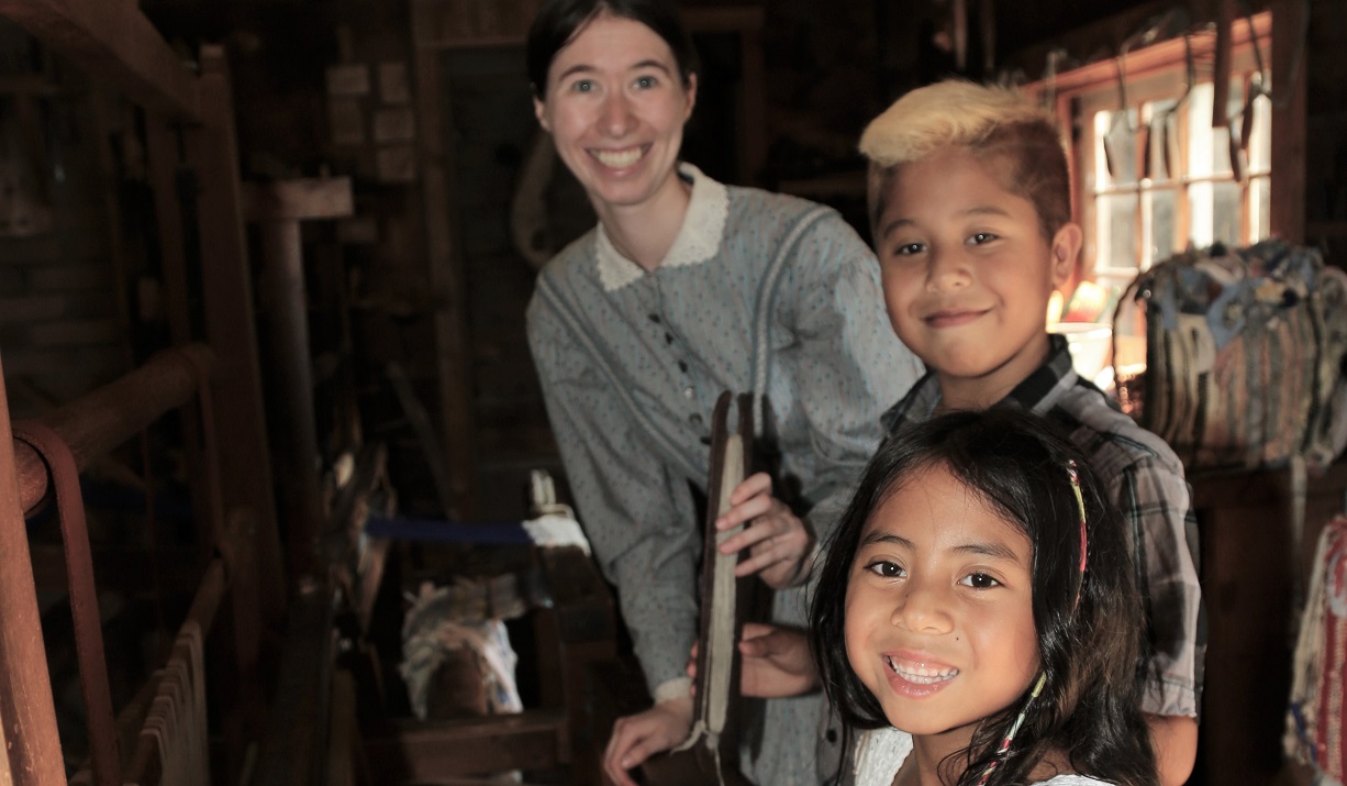 members of a community youth group enjoy a visit to The Village at Black Creek in the company of a costumed educator