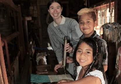 members of a community youth group enjoy a visit to The Village at Black Creek in the company of a costumed educator