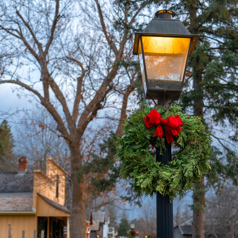 a holiday wreath adorns a street lamp at The Village at Black Creek