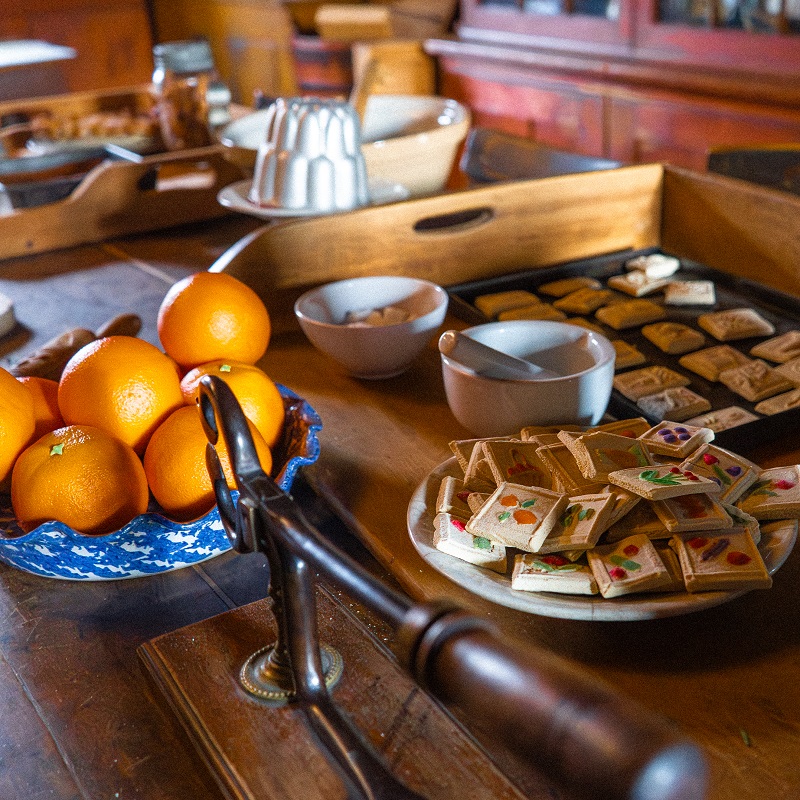 an oak table laden with traditional Victorian holiday treats at The Village at Black Creek