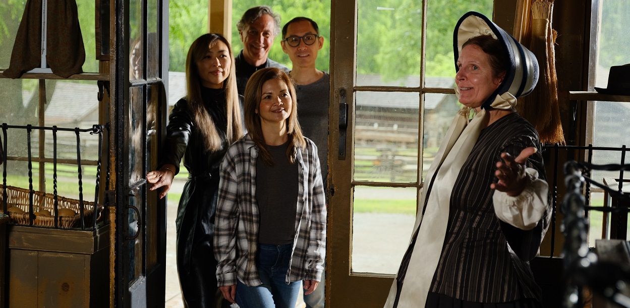 a costumed educator leads a guided weekday tour at The Village at Black Creek