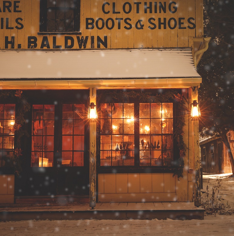 Holidays at The Village 17 snow falls on a lamp-lit street in the evening at The Village at Black Creek