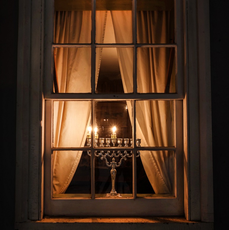 Holidays at The Village 19 a menorah in the window of a heritage home at The Village at Black Creek